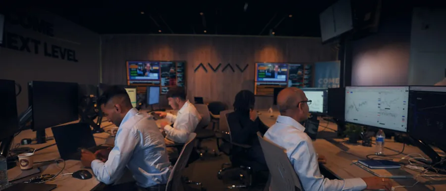 Students at their desks on the London trading floor